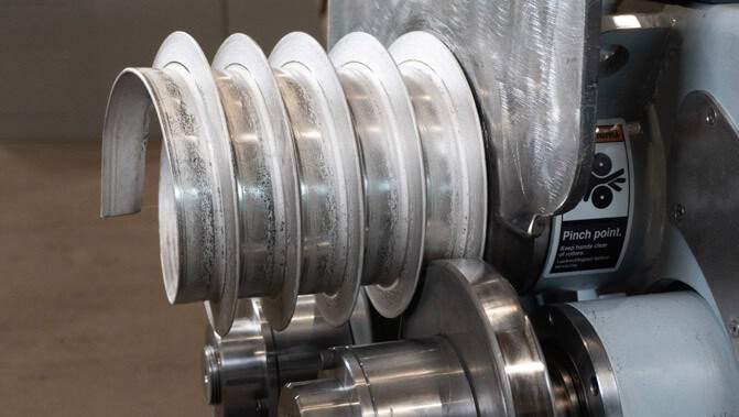 Angle bar spiralled leg-out on a SweBend SB3H-65 section bending machine