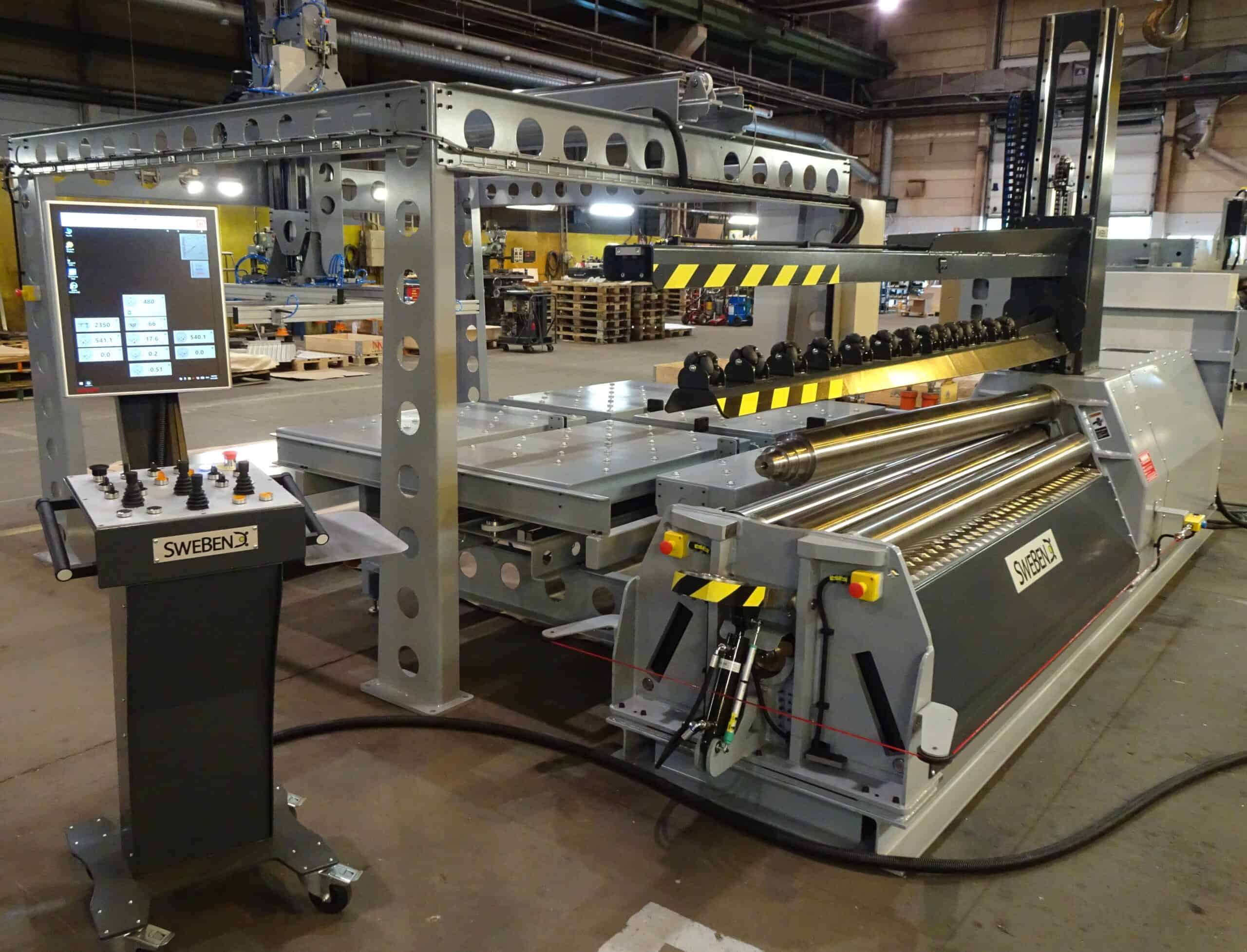 A four-roll SweBend PB4 plate rolling machine with infeed system