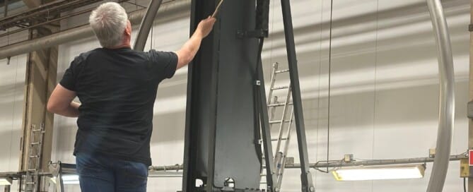 Multiple large stainless steel tubes being formed by a high-precision SweBend tube bending machine, illustrating cutting-edge tube bending technology in action on the factory floor.