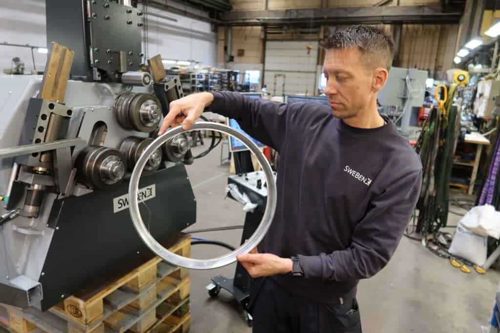 SweBend engineer holding a finished aluminium shroud ring
