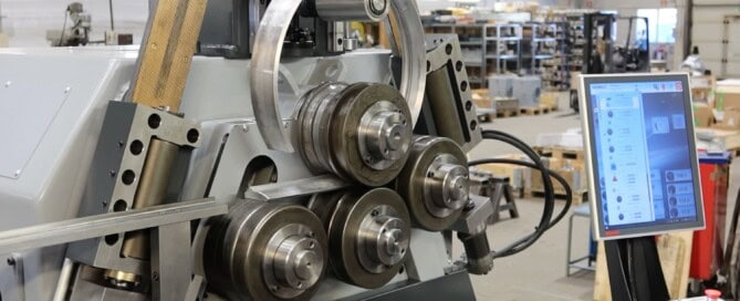 Extruded aluminium profiles being bent into shroud rings using custom rolls on the SweBend SB4 65S section bending machine.