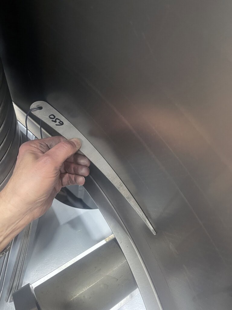 Radius gauge verifying bend accuracy on a flanged plate formed by the SweBend SB3-105 CNC bending machine
