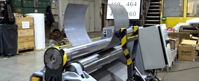 SweBend PB3-6-4 three-roll plate bending machine forming a Superduplex stainless steel cone with side support visible and digital display showing roll positions