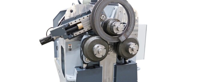 Finished closed ring of flat bar formed on the SweBend SB3X-140 section bending machine, resting on the top roll